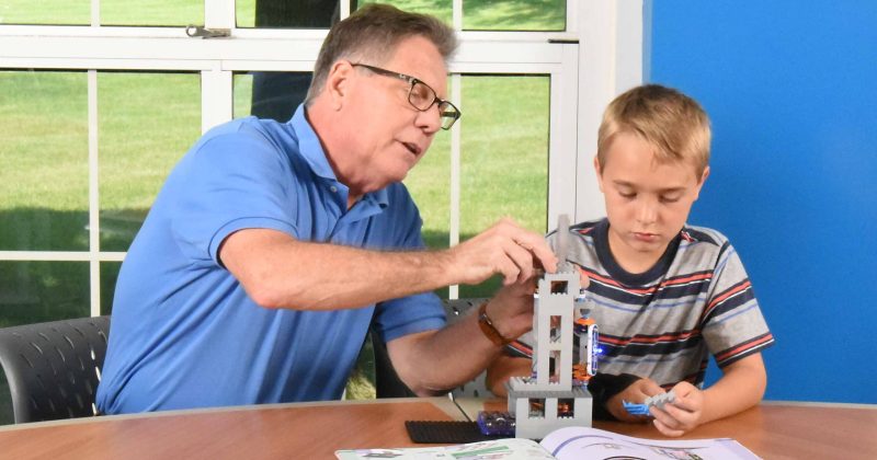 Man and boy at table playing BRIC:Structures